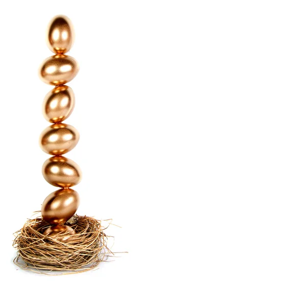 Golden eggs balanced in a nest (nest egg) — Stock Photo, Image