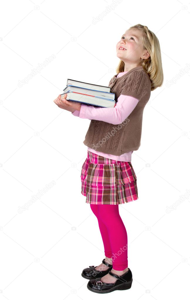 A school girl holding books looking up