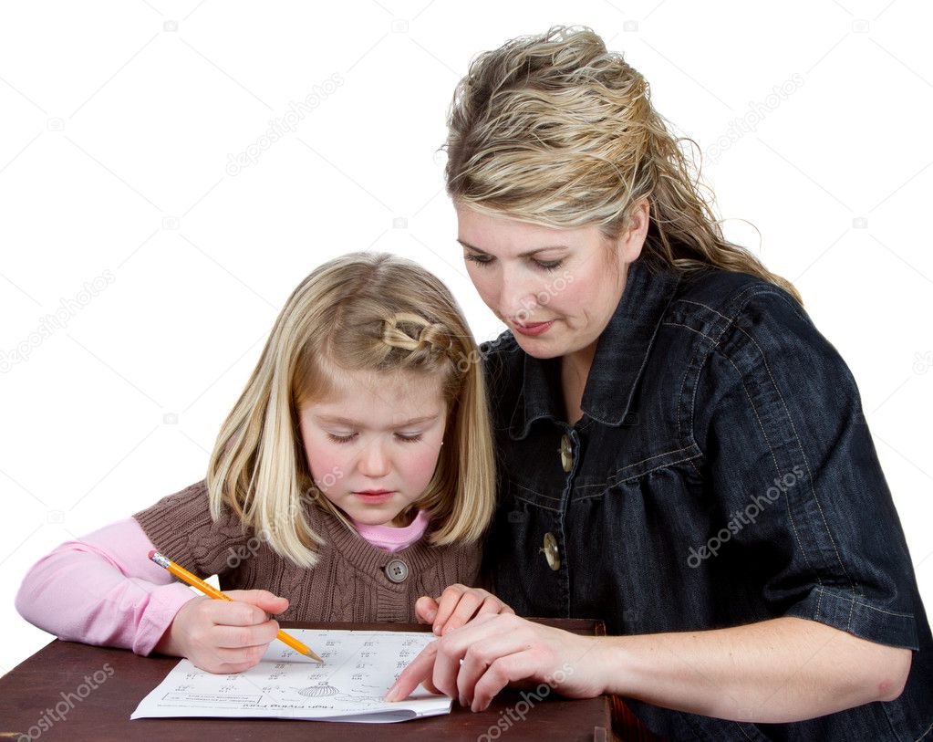 A teacher or mom helps a girl with her homework