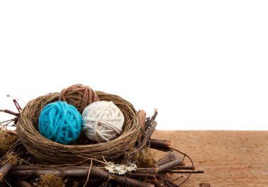 Balls of yarn in a nest, white background clipart