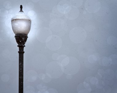 A lamp post in a snow storm clipart