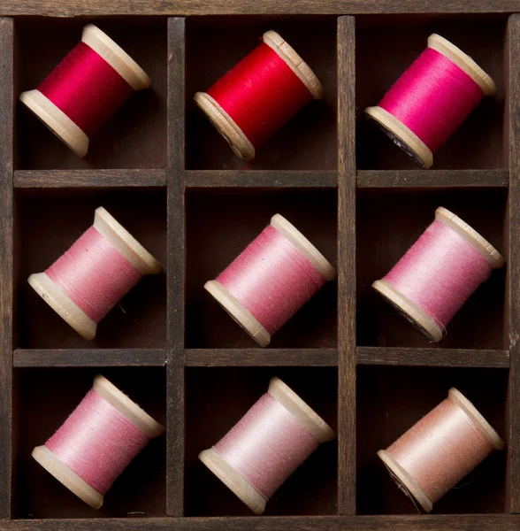 Vintage pink and red spools of thread — Stock Photo, Image