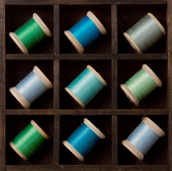 Vintage spools of thread in blues and greens — Stock Photo, Image