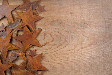 Rusty stars on a wooden background clipart