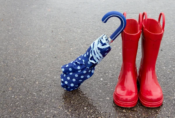 Red rain boots and umbrella — Stock Photo, Image