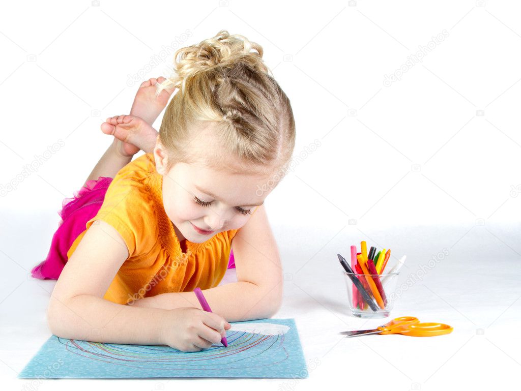 Little girl coloring a rainbow