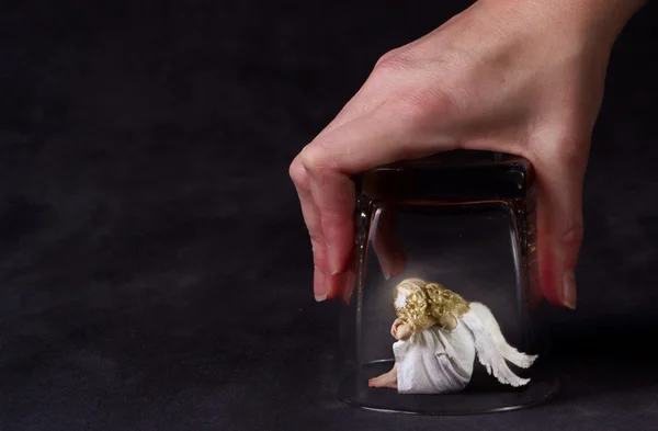 stock image An angel trapped under a glass