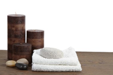 Spa still life with candles, pumice stone and towels clipart