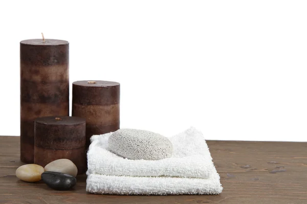 Spa still life with candles, pumice stone and towels — Stock Photo, Image