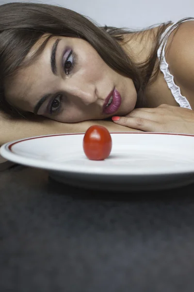 Woman watch for red tomato — Stock Photo, Image