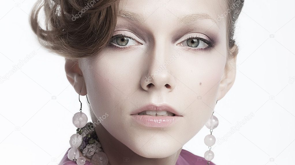 Sexy aristocratic female in earrings - beauty portrait