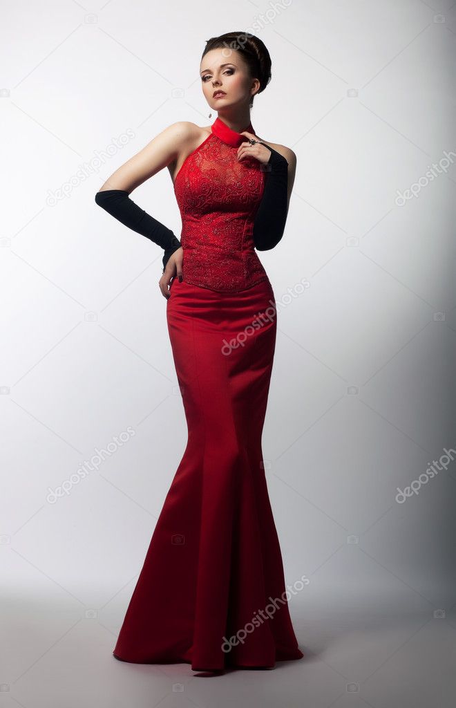 Aristocratic graceful female posing in fashion dress