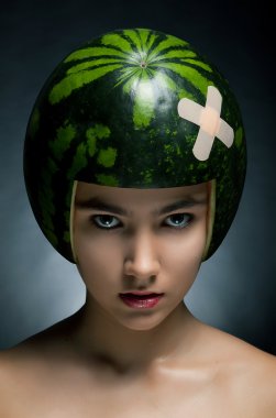 Beautiful fashion model with green fresh melon as a hard hat clipart
