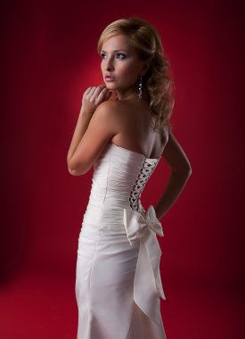 Nice blonde wedding model in white dress studio shot clipart