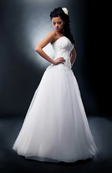 Beautiful bride brunette in wedding white dress on podium — Stock Photo, Image