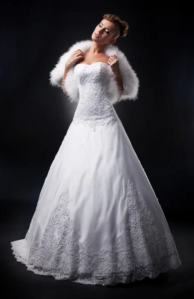 Krásná nevěsta ve svatebních šatech a boa na pódiu vystupují — Stock fotografie