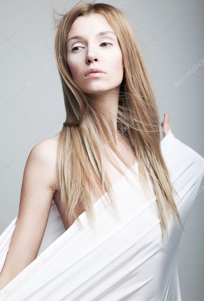 Lovely gentle half-dressed girl in white clothes like cocoon
