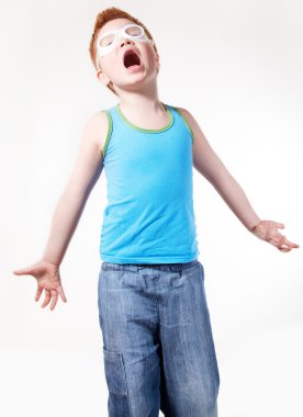 Redhead crying disappointed little boy posing. Studio shot clipart