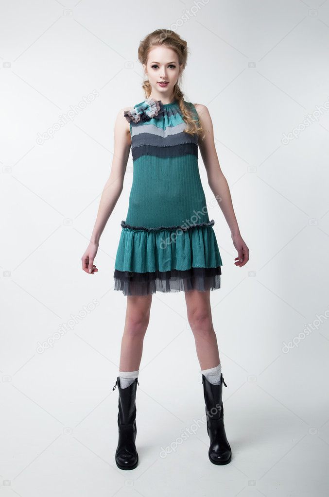 Lovely young fashion model female in modern dress standing