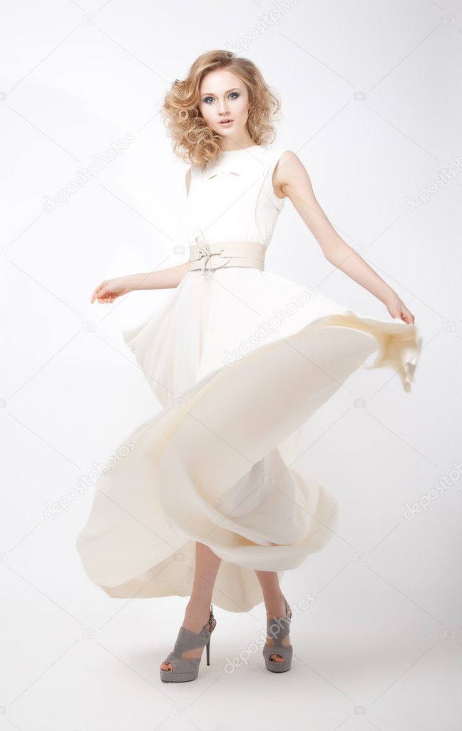 Lifestyle - fashionable young female in light flying dress
