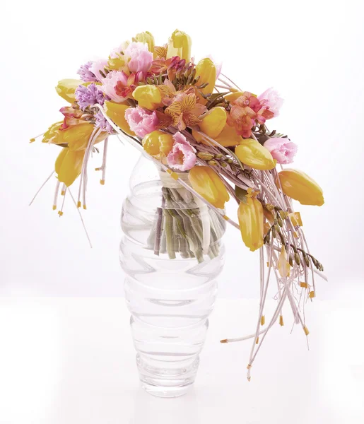 Colorata disposizione floreale in vaso di vetro con tulipani gialli — Foto Stock