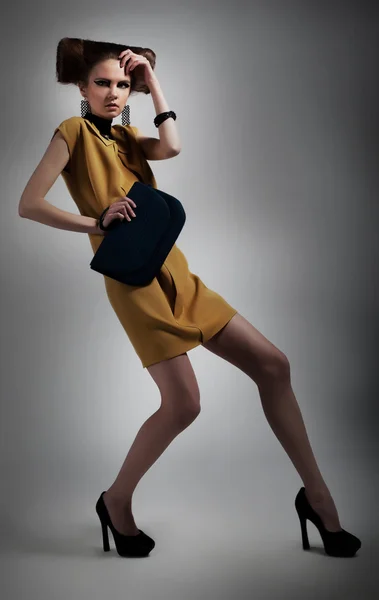 Elegant fashionable artistic girl in studio posing — Stock Photo, Image
