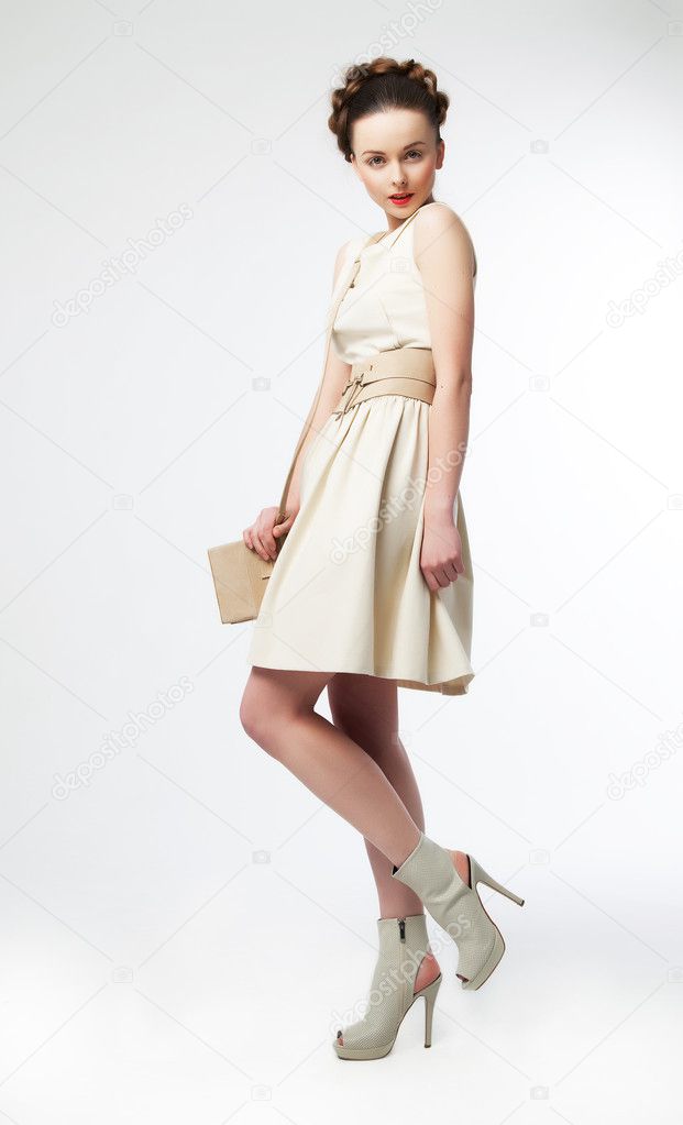 Cute woman fashion model in retro dress posing