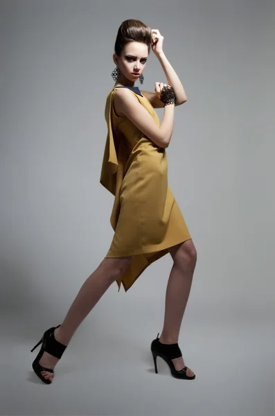 Módní dívka v moderních šatech pózuje ve studiu — Stock fotografie