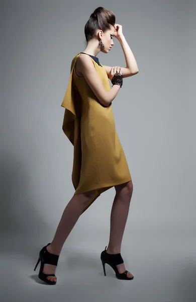 Fashionable emotional woman in modern yellow dress — Stock Photo, Image