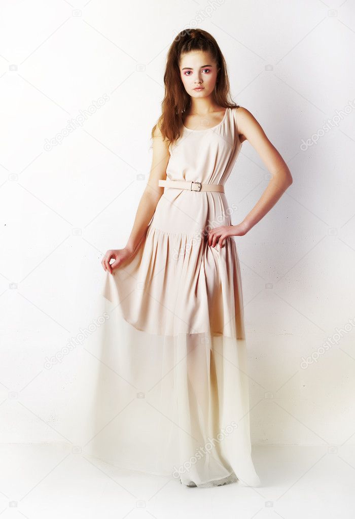 Fashion style - stylish girl in funky long dress posing