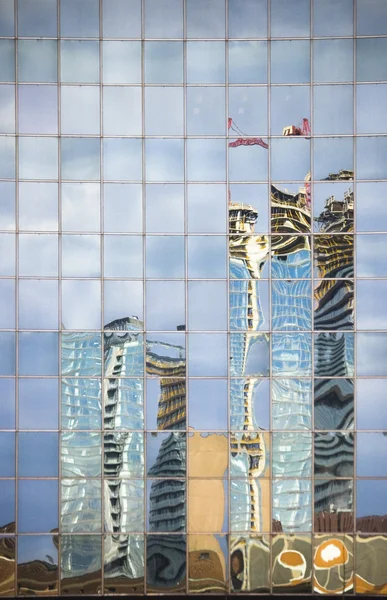 Street reflecting in the glass of modern building — Stock Photo, Image
