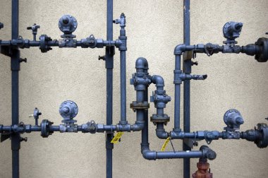 Plumbing pipes on rough wall clipart