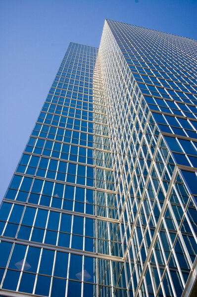 Tall skyscraper against sky; finance or technology concept