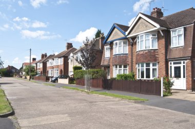 Street of semi detached & detached houses in urban area clipart