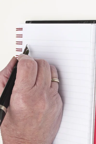 Schreiben auf ein leeres Notizbuch — Stockfoto