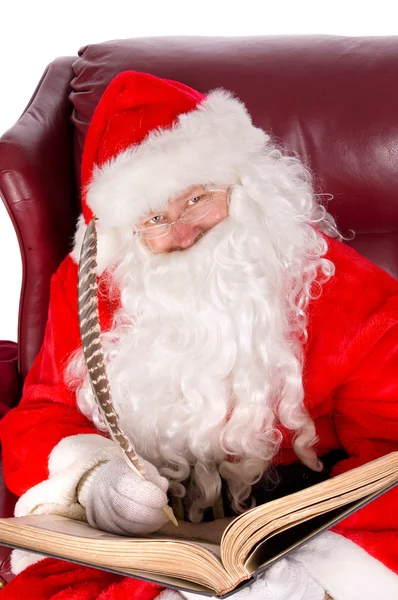 Weihnachtsmann schreibt ins Namensbuch der guten Kinder — Stockfoto