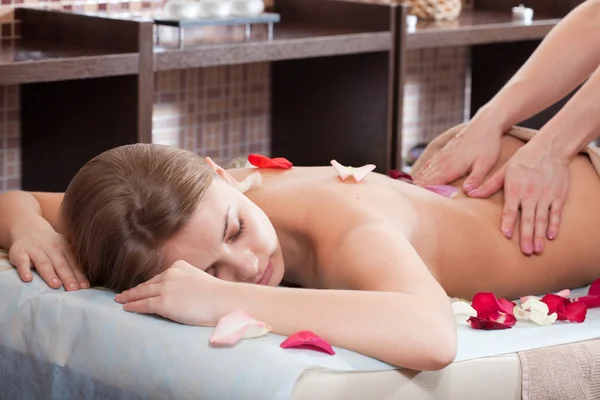 stock image Woman enjoying a massage in a spa setting