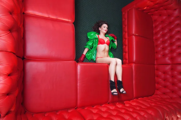 Criatividade - uma menina em um sofá vermelho — Fotografia de Stock