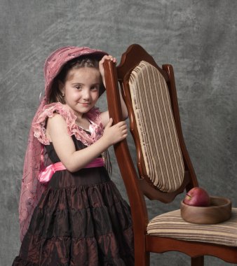 Little girl with apple on a saucer clipart