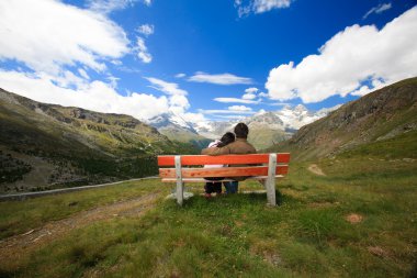 A lovely couple enjoying the beautiful mountain view clipart