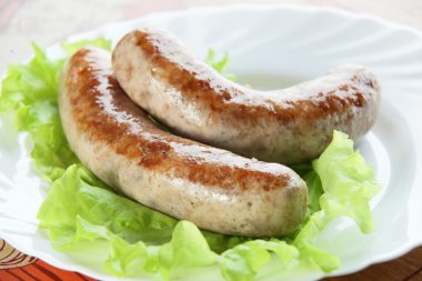 Two sausages on plate clipart