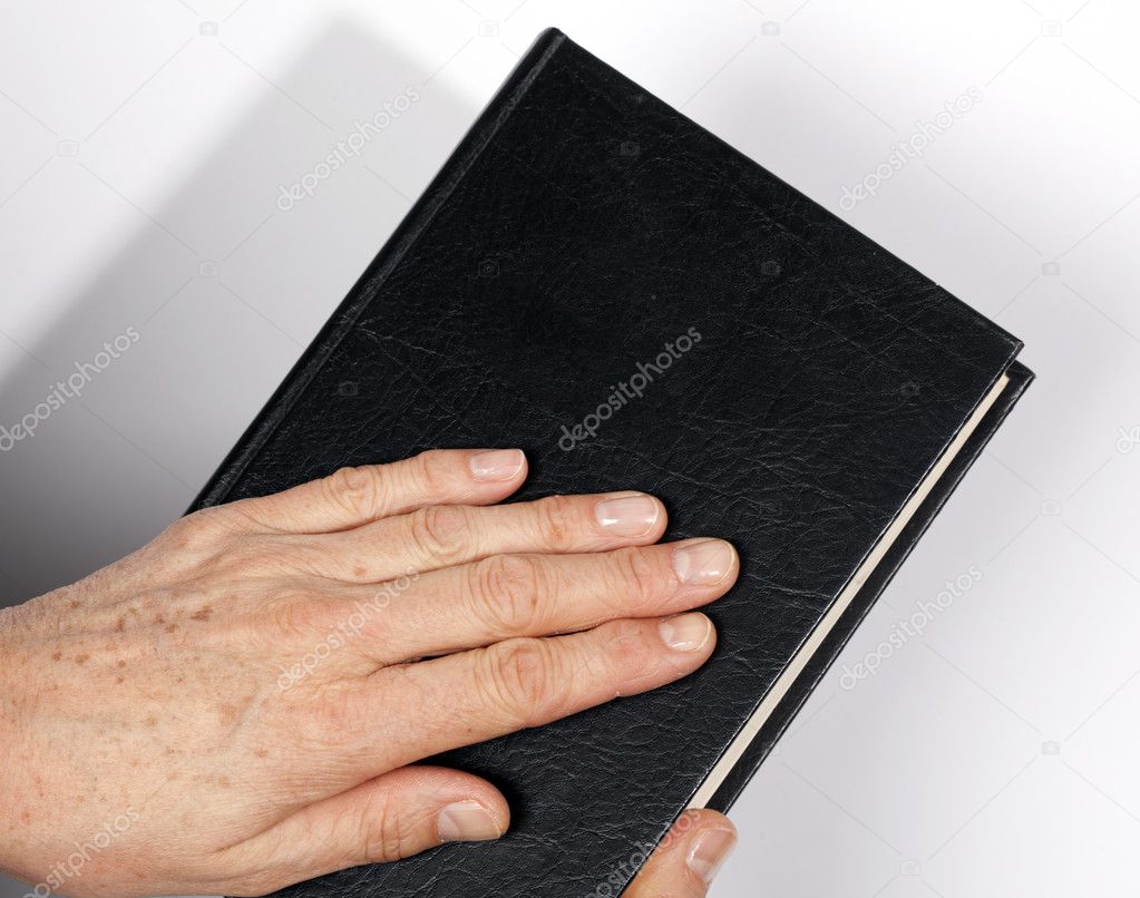 Bible with hand