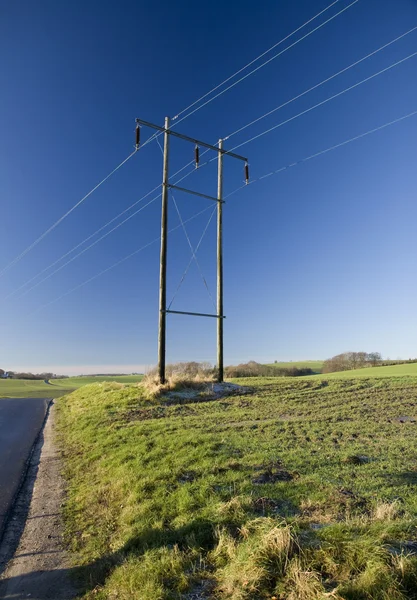 Power pylon in the field — Stock Photo, Image