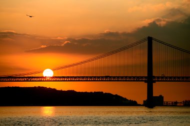 Lisbon bridge at sunset clipart