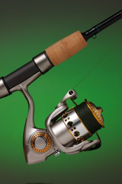 Spinning reel attached to a cork handled fishing pole clipart