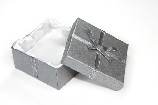 Open silver gift box with ribbon and bow — Stock Photo, Image