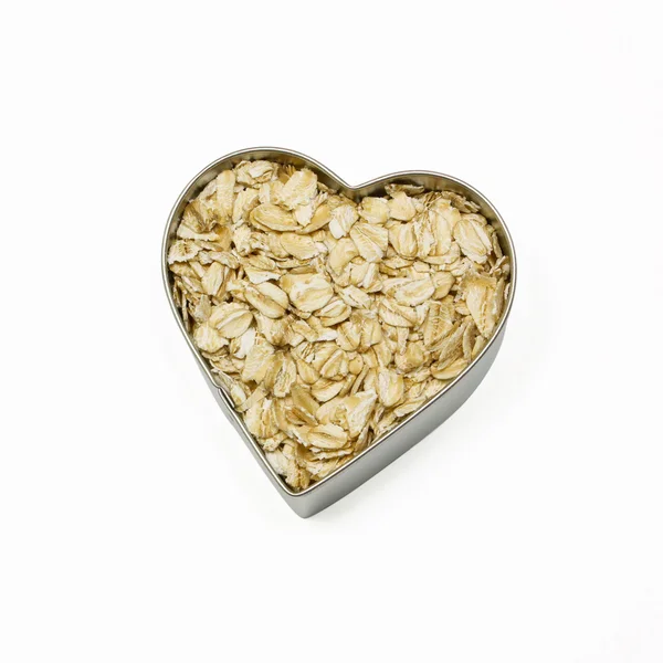 Heart filled with oatmeal — Stock Photo, Image