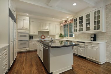 Kitchen with cream colored cabinetry clipart