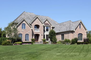 Brick home with front balcony clipart