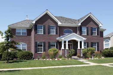 Brick home with arched entry clipart